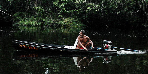 Fishing in his canoe...
