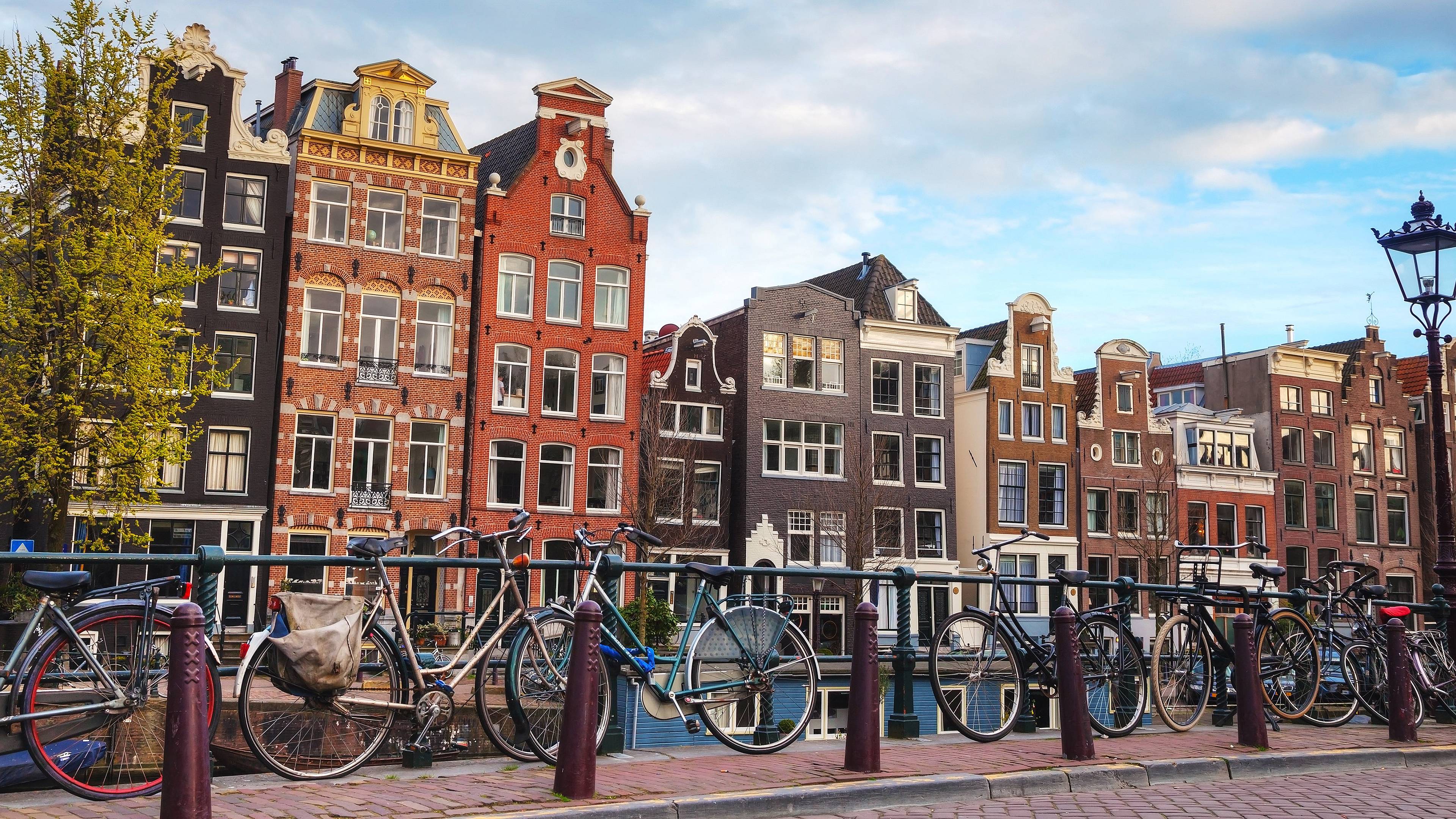 Des vélos sur un pont à Amsterdam, devant des immeubles